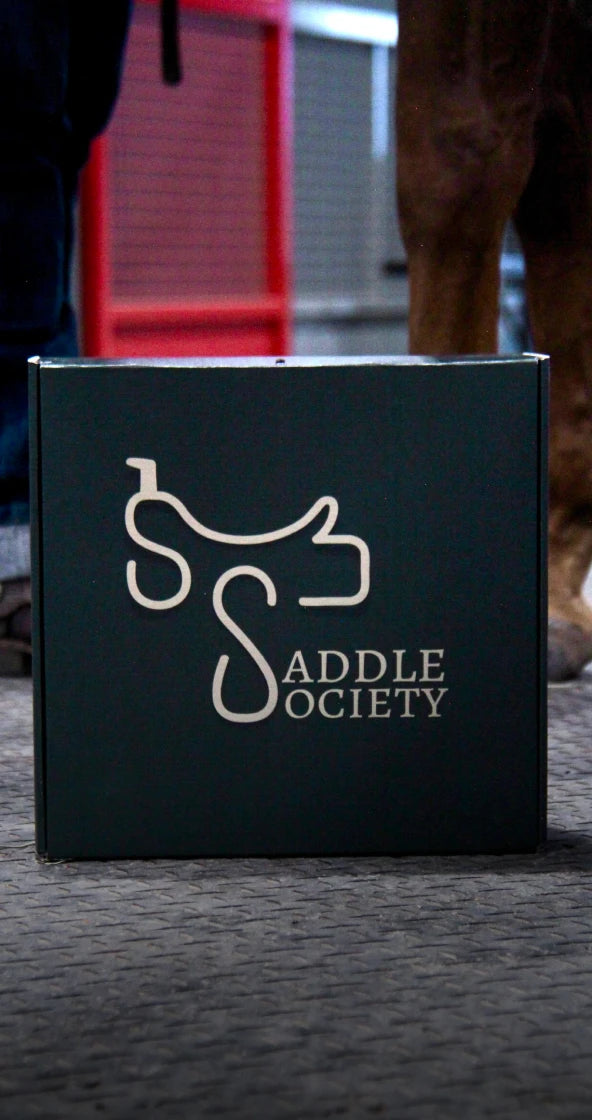 Saddle Society Signature Box on floor of barn